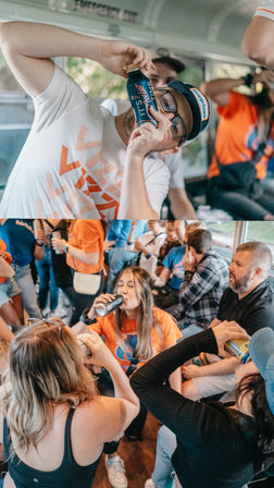 Crowded party bus interior with young adults drinking canned beverages, laughing and celebrating, several wearing orange shirts and casual gear.