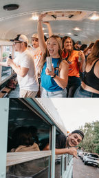 Smiling group of young adults partying inside a converted school bus with canned drinks, one leaning out the window making a shaka sign as the bus sits on a tree-lined neighborhood street.