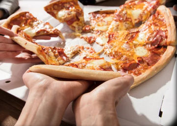 Hands reaching for melty pepperoni pizza slices in an open takeout box — golden crust and stretchy cheese, perfect for sharing.