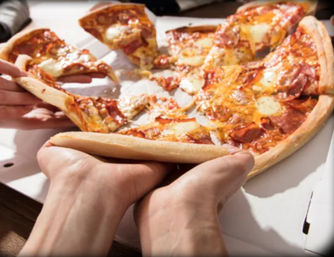 Hands pulling a gooey pepperoni pizza slice from an open white takeout box, melty cheese stretching over a golden crust