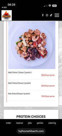 Top-down shot of a hibachi-style plate with grilled shrimp, scallops, lobster, cubed steak and mixed vegetables on a white plate, shown above menu pricing for adult and kids options.