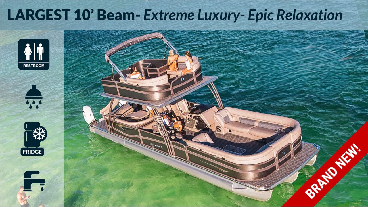 Aerial view of a brand-new double-deck luxury 10-foot beam pontoon boat floating in clear green water, with passengers relaxing on upper and lower decks and left-side icons indicating restroom, shower, fridge, and sink.