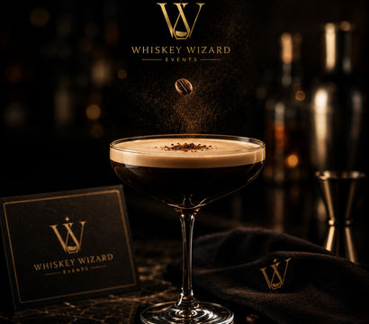 Velvety espresso martini in a coupe glass with a coffee bean suspended above cocoa dusting, gold-accented menu and cocktail tools on a dark marble bar surface — upscale cocktail lounge vibe.