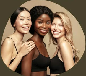 Studio portrait of three smiling women with varying skin tones in black camisoles posing closely against a neutral beige backdrop — diverse beauty and skincare concept.