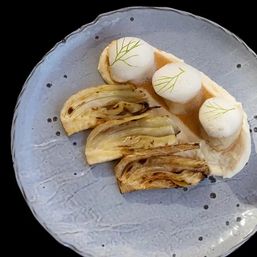 Fine-dining plate with three pillowy white foam quenelles topped with tiny herb fronds on a pale cream sauce, paired with three caramelized fennel wedges on a textured grey ceramic plate.