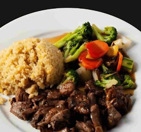 Savory beef stir-fry with broccoli, carrots and mixed vegetables served with golden fried rice on a white plate