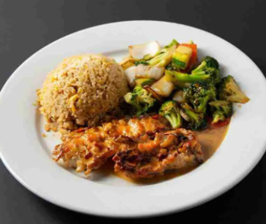 Asian-style dinner plate with grilled chicken in savory sauce, a mound of fried rice and stir-fried broccoli and onions on a white plate