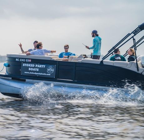 Group of friends enjoying a pontoon boat cruise on a sunny summer lake, splashing through the wake — waterfront boat rental party