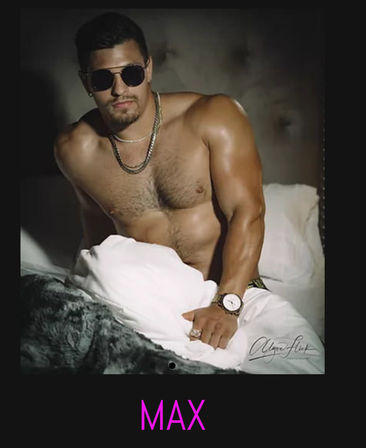 Shirtless male model wearing sunglasses, layered chains and a watch lounging on a bed with white pillows and a faux-fur throw, stylized "MAX" caption below.