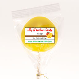 Bright yellow mango lollipop on a stick, wrapped in clear cellophane with a "Mango" label and mango illustration, tied with a gold twist tie on a white background.