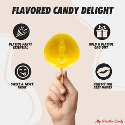 Hand holding bright yellow novelty lollipop shaped like a vulva on a stick against a pale background, playful adult party candy ad promoting gag gift and sweet treat