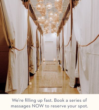 Cozy spa corridor lined with curtained massage pods, jute rugs and warm hanging lights, with a promo message urging guests to book a series of massages.