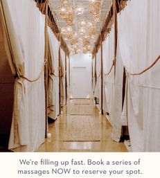 Cozy boho-chic spa corridor with curtained massage treatment rooms on both sides, warm woven pendant lights and natural-fiber rugs on a wooden floor, with overlay text urging booking of a massage series.