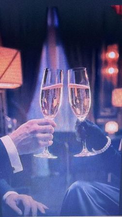 Two champagne flutes clinking in a glamorous evening toast, hands in formal attire (suit sleeve and gloved hand) against warm lounge lighting