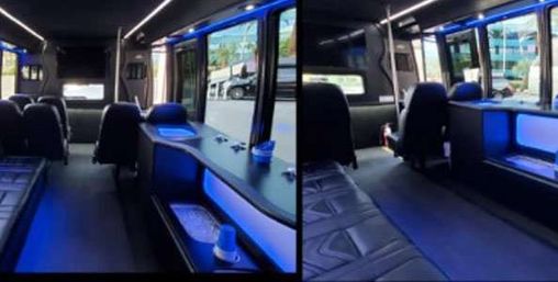 Split-view interior of a luxury shuttle van with black leather seating and captain chairs, built-in counter and cupholders, blue LED accent lighting, and large windows showing an urban street outside.