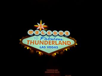 Retro neon welcome sign topped by a glowing star, with illuminated 'Las Vegas' text against a black night sky