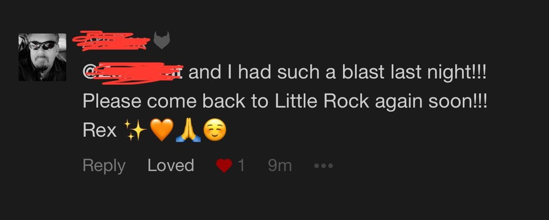 Screenshot of a social media comment: a small profile photo and redacted username, fan says they “had such a blast last night” and asks to “please come back to Little Rock again soon” with sparkles, orange heart, praying hands and smiling emojis; a Loved heart reaction is visible.