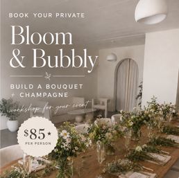 Private floral workshop setup in a bright minimalist studio: long wooden table with hand-tied wildflower bouquets, champagne flutes, place settings and neutral seating — "Bloom & Bubbly" event, $85 per person