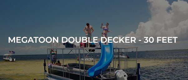 30-foot double-decker pontoon boat with a bright blue slide and people on the top deck enjoying a sunny day on coastal waters with other boats in the distance