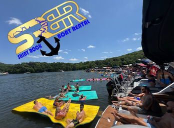 Sun-soaked lake party with people lounging on bright floating mats and crowded boats along a wooded shoreline, colorful logo overlay in the sky