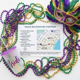 Festive Mardi Gras flat lay with purple, green and gold bead necklaces and a feathered mask surrounding a 'Historic New Orleans Bar Crawl Route' map and a translucent cup labeled 'Bride' — New Orleans party planning theme.