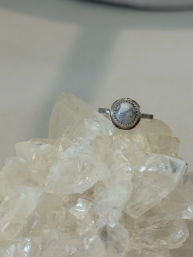 Silver ring with a round white marbled cabochon set atop a clear quartz crystal cluster — minimalist boho jewelry product photo