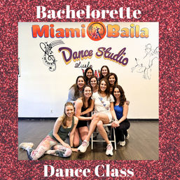 Bachelorette dance class group in a Miami dance studio — bride-to-be wearing a sash seated with friends smiling in front of a colorful wall mural.