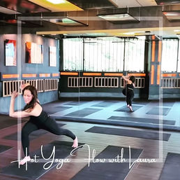 Person in black athletic wear lunging on a mat in a mirrored indoor hot yoga studio with wooden floors, orange accent lighting, and rows of mats; image overlay promotes a hot yoga flow class.