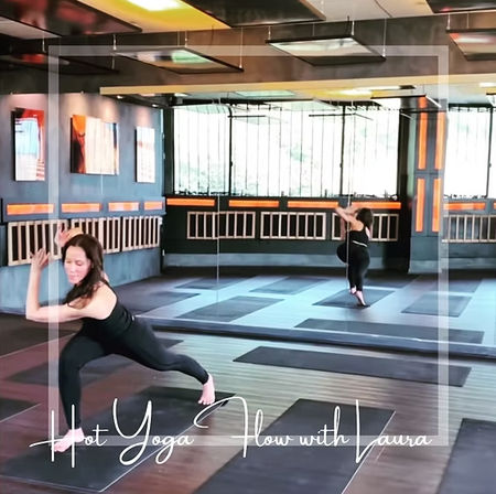 Person in black athletic wear lunging on a mat in a mirrored indoor hot yoga studio with wooden floors, orange accent lighting, and rows of mats; image overlay promotes a hot yoga flow class.