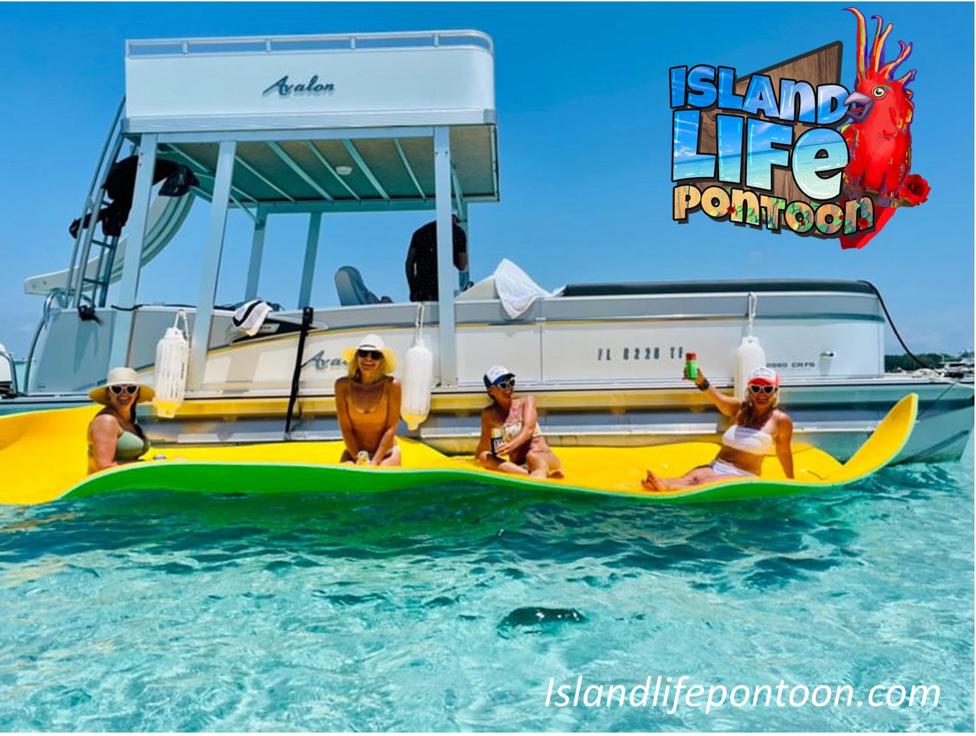 Four people in swimsuits and sun hats lounging on a bright yellow inflatable mat beside a white pontoon boat in crystal-clear turquoise water on a sunny day, holding drinks.